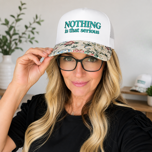 NOTHING IS THAT SERIOUS FLORAL BRIM TRUCKER HAT
